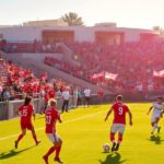 Soccer match in San Diego with players and cheering fans.