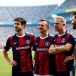 Soccer players on the field reflecting on their careers.