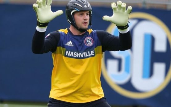 Brian Schwake in Nashville SC goalkeeper gear making a save.