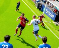 Soccer players in action on a vibrant green field.