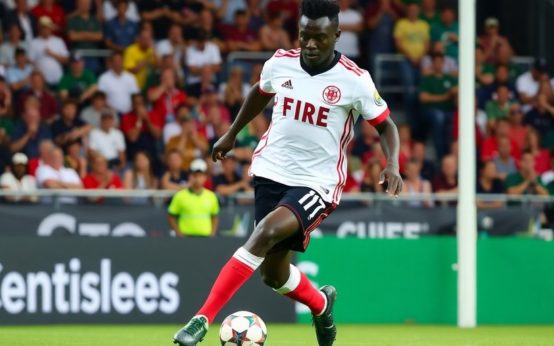 Rominigue Kouamé dribbling the ball for Chicago Fire.