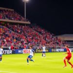 Soccer players on a field during an MLS match.