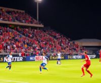 Soccer players on a field during an MLS match.