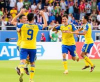 San Diego FC players celebrating a goal with fans.