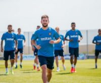 Lionel Messi training with Inter Miami teammates on the field.