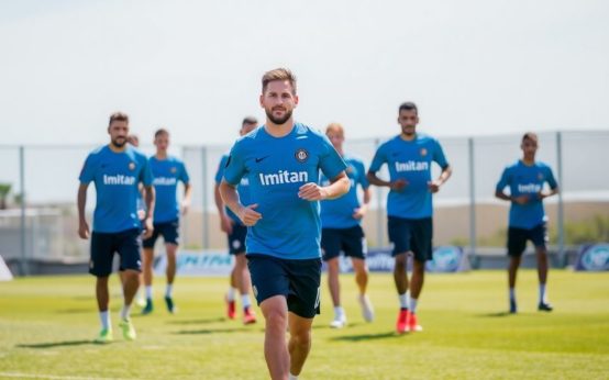 Lionel Messi training with Inter Miami teammates on the field.